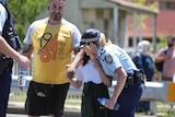 Police officer hugs student