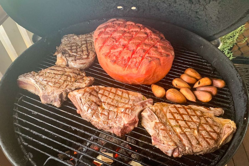Meat and watermelon on a barbecue.