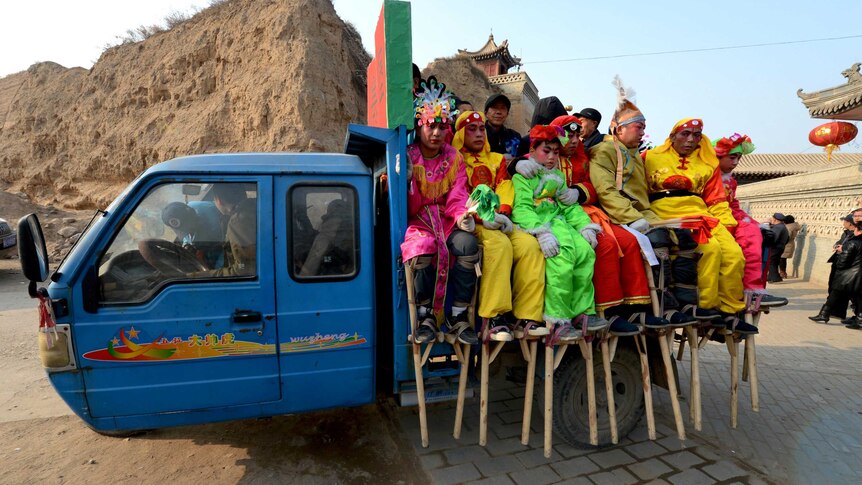 Entertainers leave for A Lantern Festival parade in Nuanquan, China.