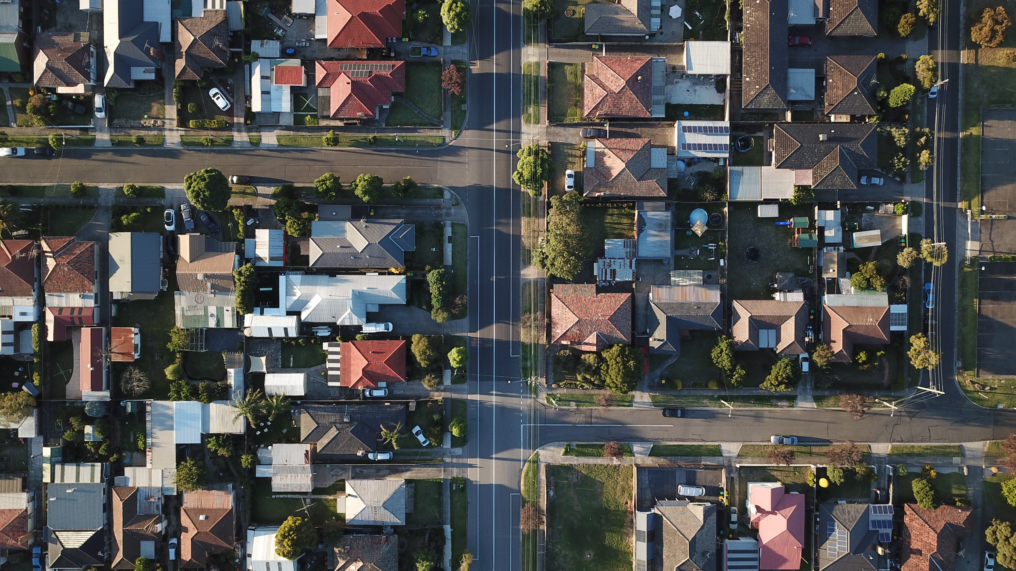 Drone view of housing rooftops and roads