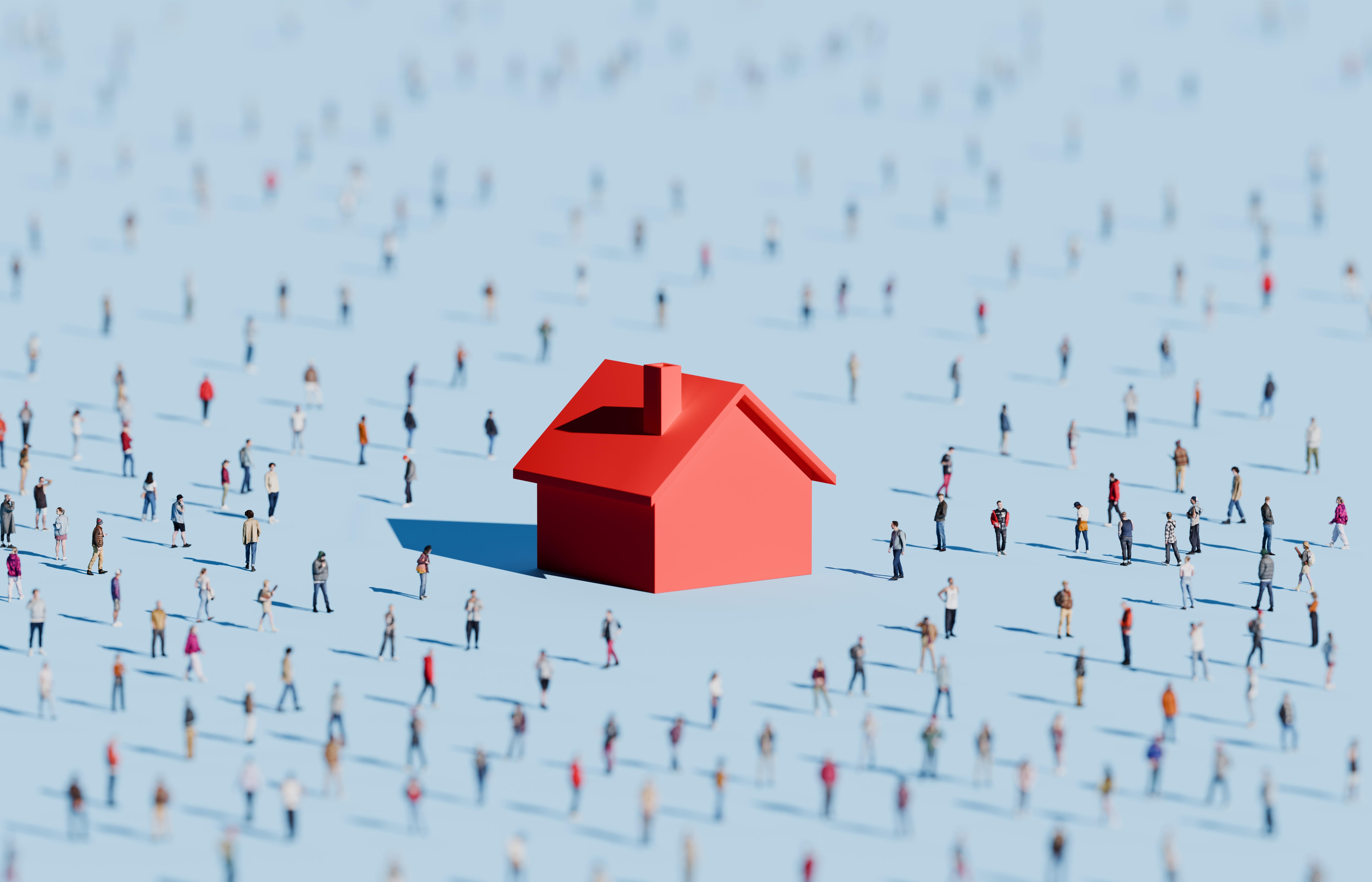 Conceptual image of an oversized housing symbol in a large crowd of people