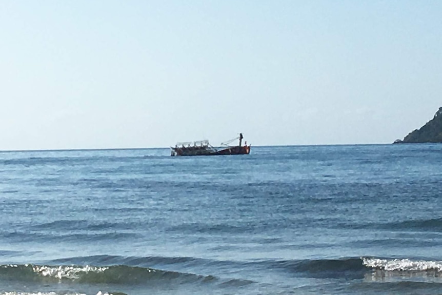 Fishing boat partly sunk off the coast of the Daintree in far north Queensland.