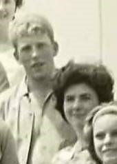 An old black and white photo of a young man and women standing next to each other