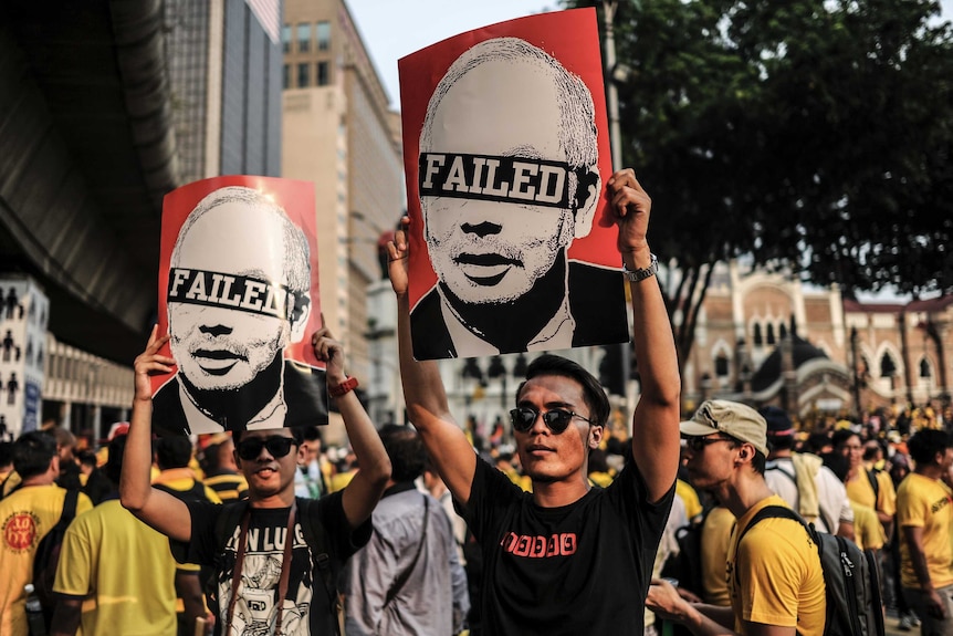 Protestors display placards during a demonstration demanding prime minister Najib Razak’s resignation