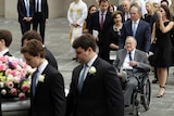 Former president George HW Bush and George W Bush follow Barbara Bush's coffin after her funeral service.