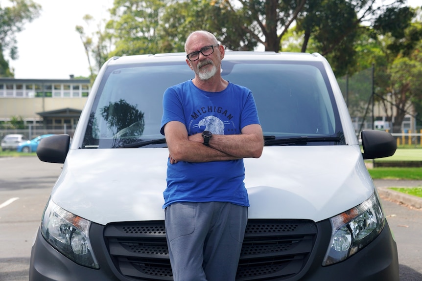 man in front of van