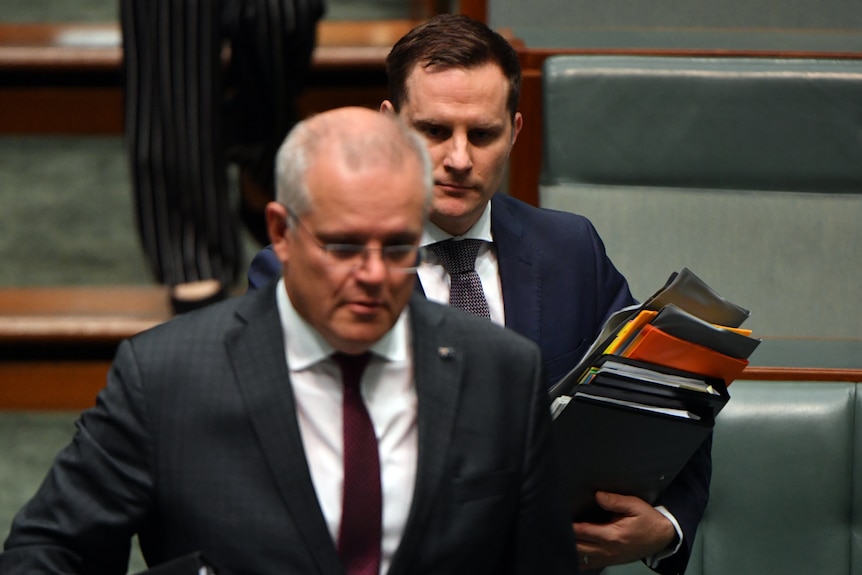 Two men in suits in parliament.