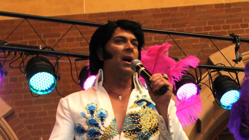 An Elvis impersonator performs before boarding the Elvis Express to Parkes.