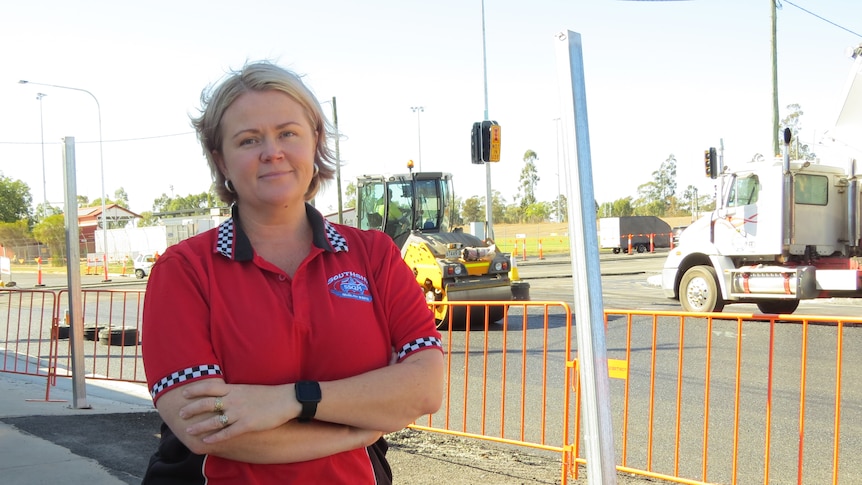 Elisha Beil stands in front of the roadworks outside her shop.