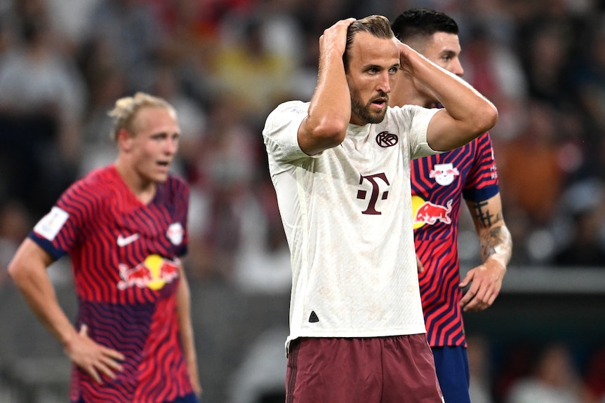 Harry Kane puts his hands through his hair as he reacts during his Bayern Munich debut.