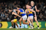 Two Carlton and two West Coast AFL players look to move towards the ball after a centre bounce.