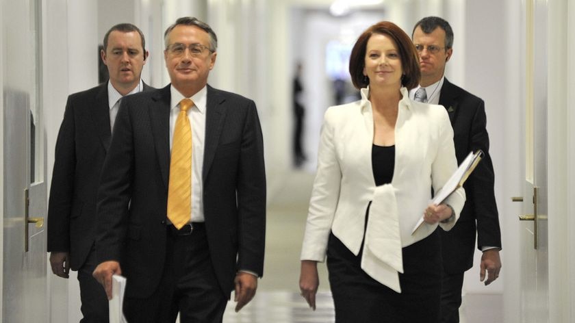 Labor's day: Prime Minister Julia Gillard and Treasurer Wayne Swan are all smiles after claiming a narrow victory over the Coalition.
