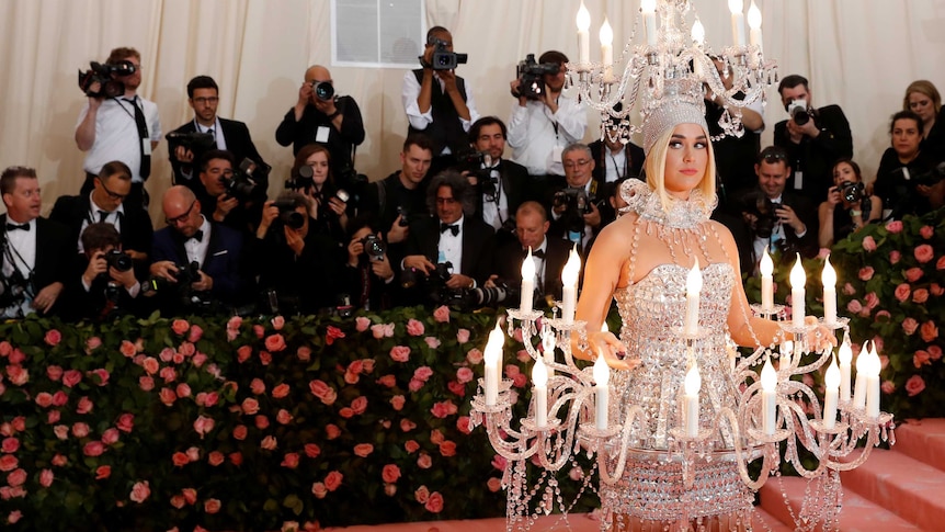 Katy Perry dressed as a chandelier at the Met Gala, in a story about why the Met Ball is ridiculous but important.