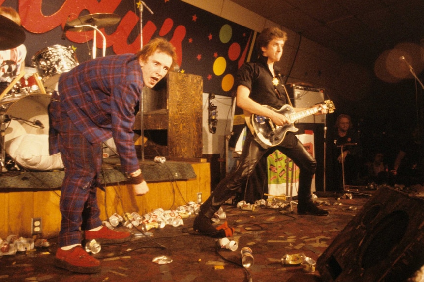 Two musicians from punk band, The Sex Pistols, performing on stage in 1978.