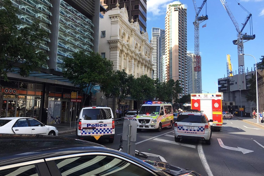 Police and emergency services vehicles at the scene in Queen Street in Brisbane.