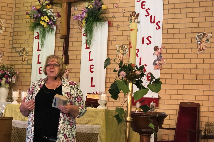 Woman standing in front of the altar in a church