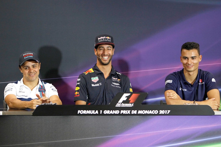 Daniel Ricciardo smiles next to Felipe Massa of Brazil and Pascal Wehrlein of Germany