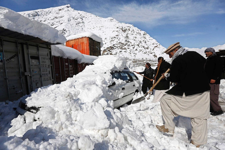 Afghan men remove snow in Panjshir province, Afghanistan