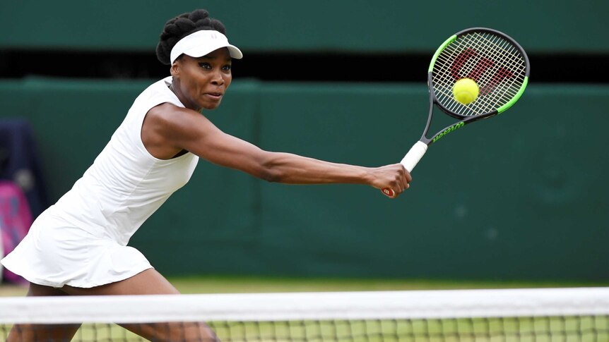 Venus Williams reaches out with her racket to hit the ball during the Wimbledon final.