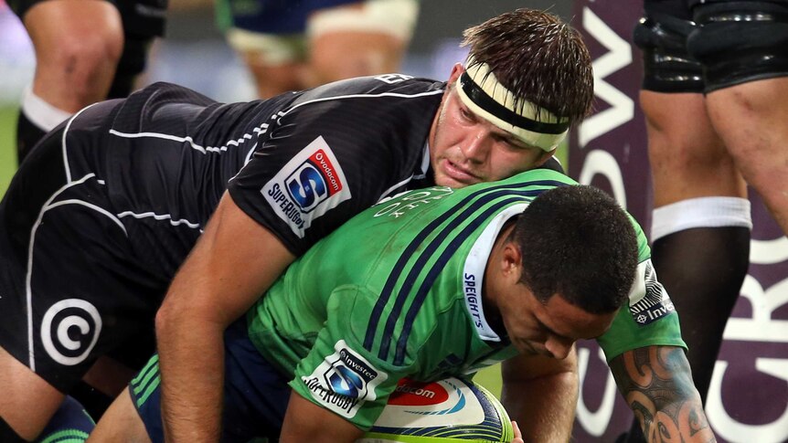 Squeezing through ... Aaron Smith scores a try amid the defensive pressure of Stephan Lewies