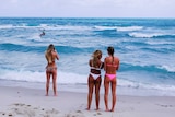 Girls stand on a beach in Miami