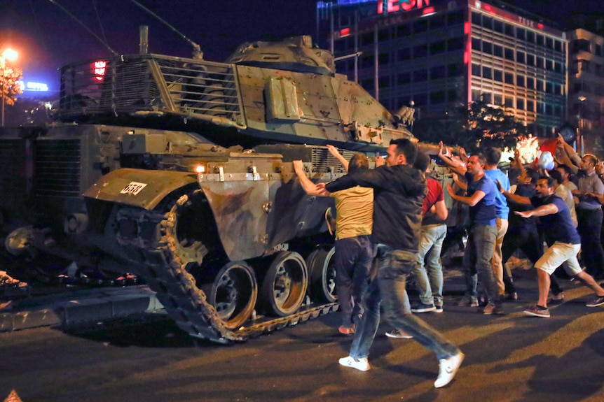 Dozens of people surround a military vehicle during an attempted coup in Ankara, Turkey