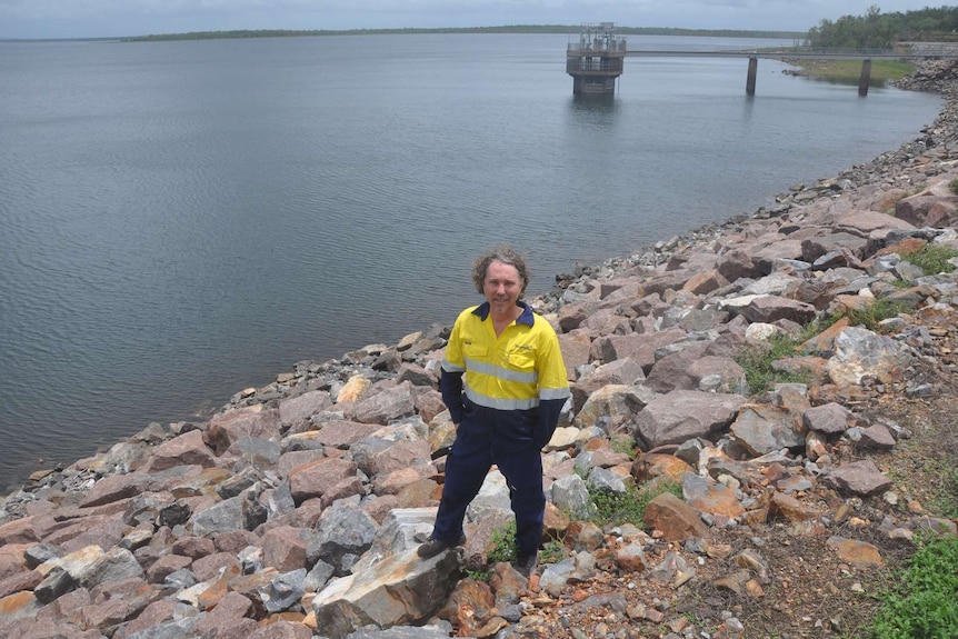 Trevor Durling stands on the rocky banks of the Darwin River Dam.