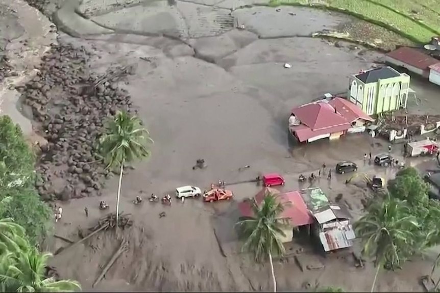Aerial view shows a town inundated by water and mud.