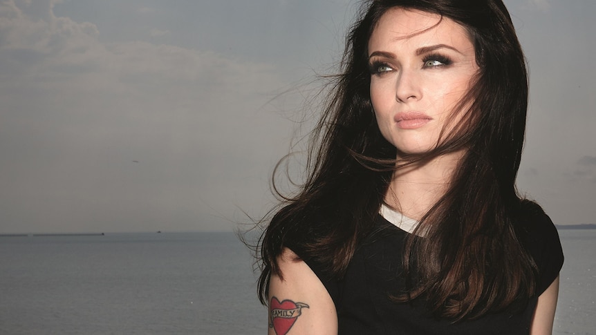 Sophie Ellis-Bextor stands on a pier staring into the distance
