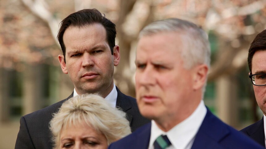 Senator Matt Canavan looks at National leader Michael McCormack at a doorstop