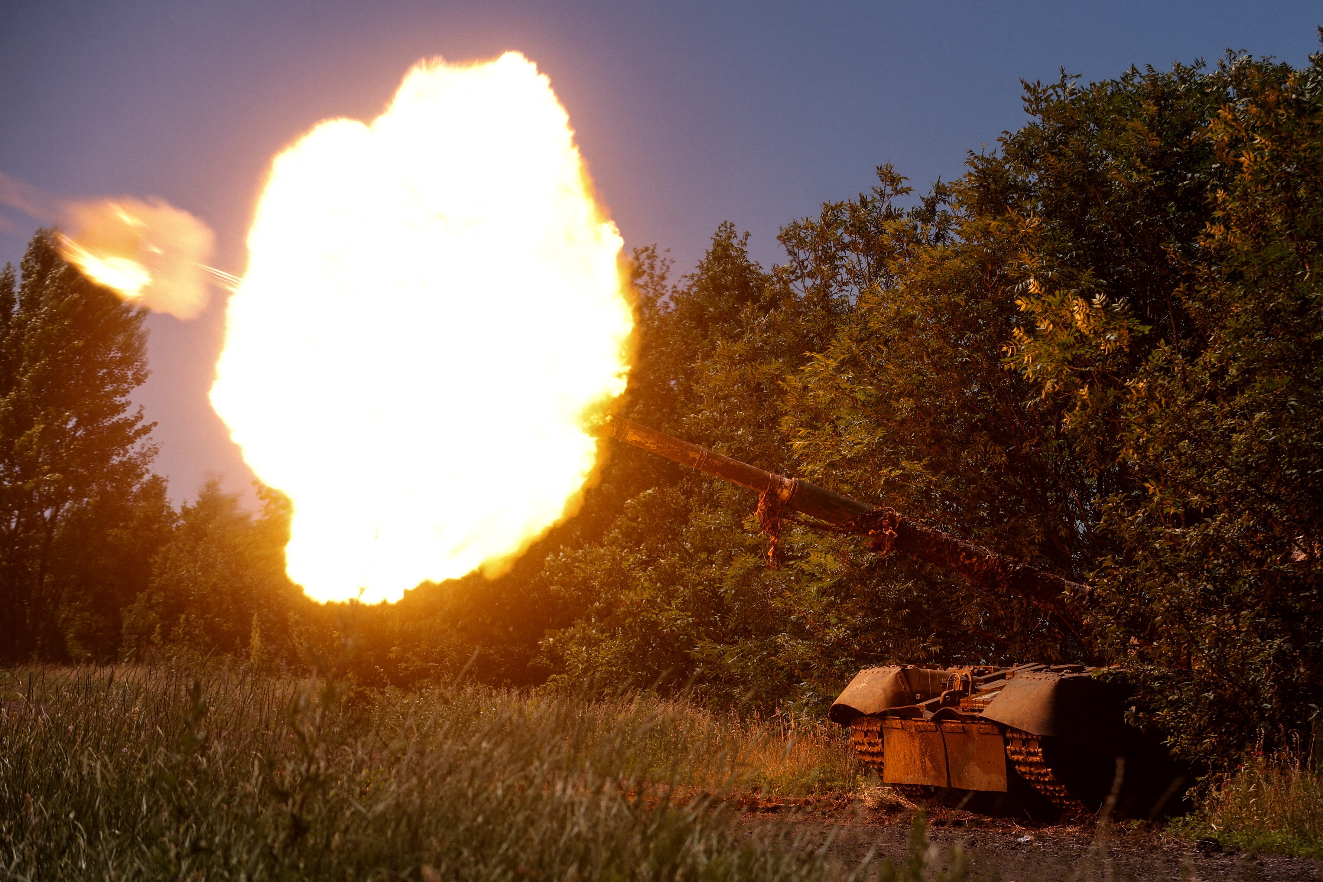 A tank is seen firing a large ball of fire.