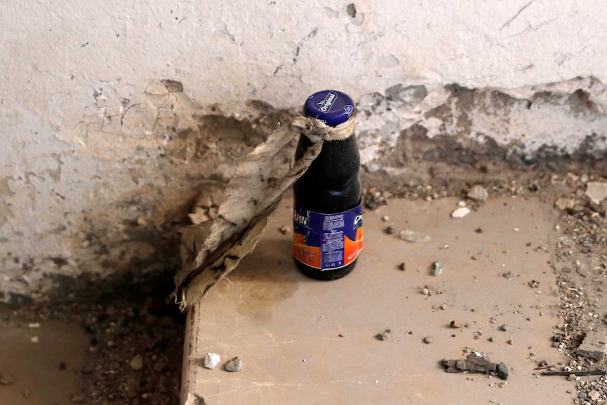 An unexploded bomb inside a juice bottle is pictured near the bunker of the Islamic State militants.