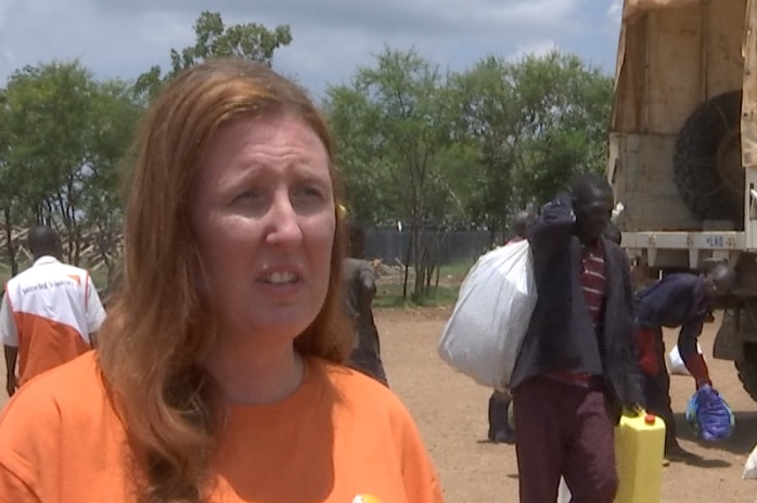 Carly Sheehan speaks to the ABC as the UNHCR delivers supplies.