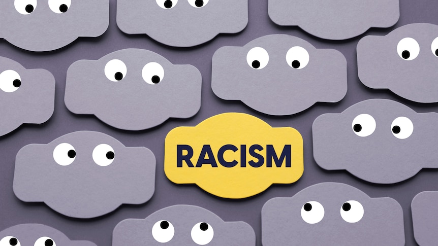 labels with googly eyes on a grey background and a yellow one in the middle with the word racism on it