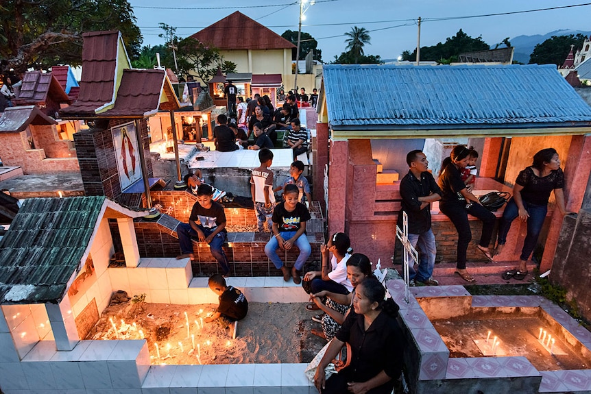 Parents and children light candles at the memorials.