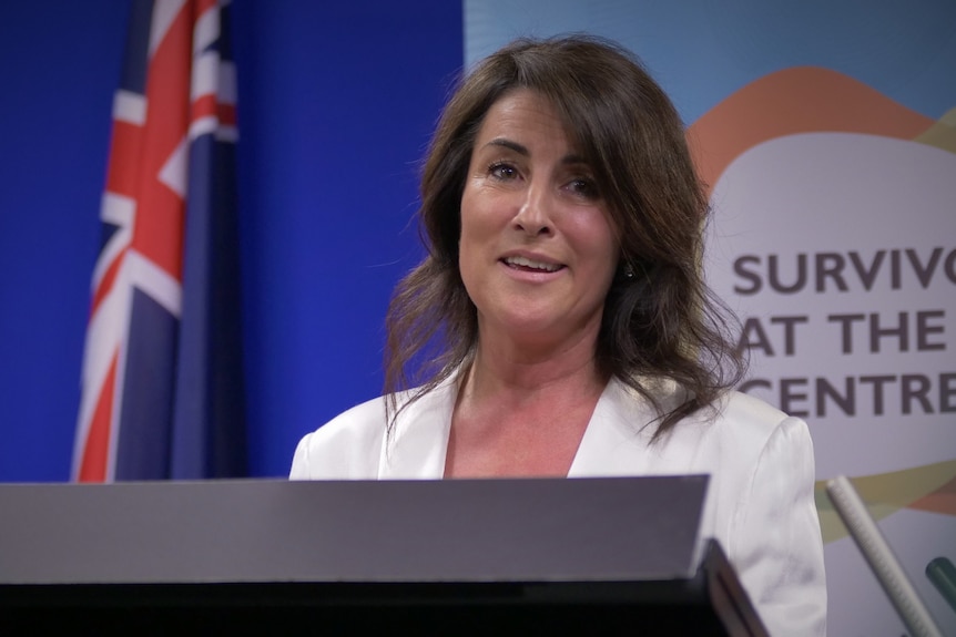 Jo Palmer speaks at a lectern.