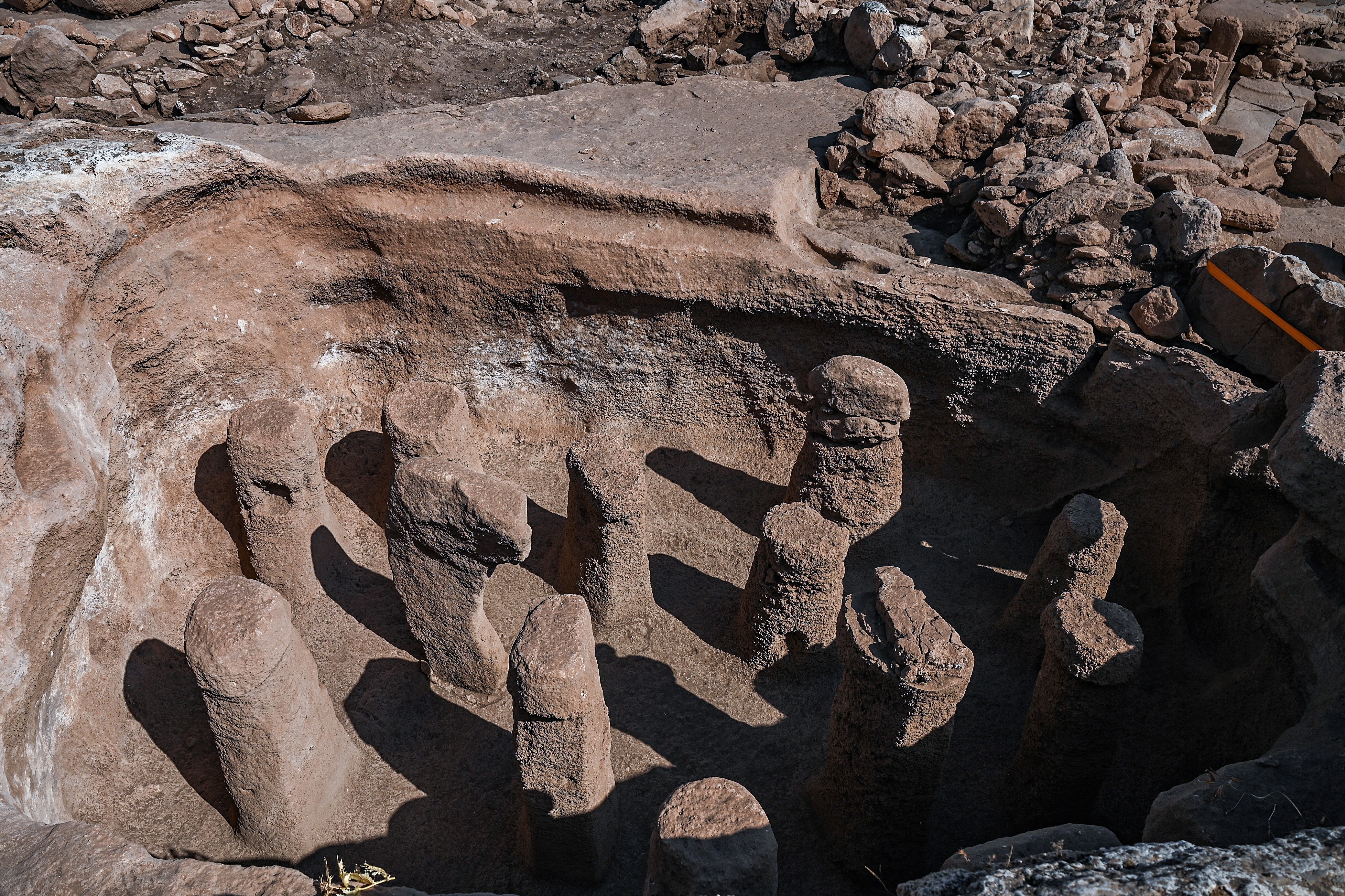A dig site where various stone towers stand.