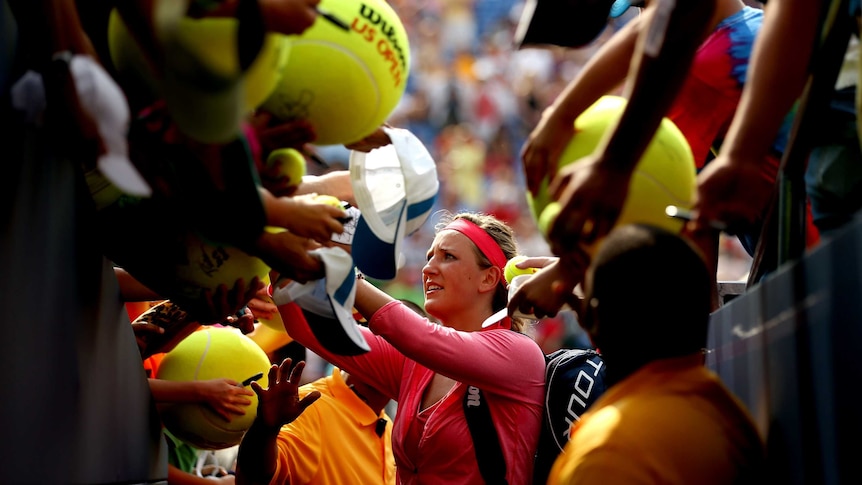 Belarus' Victoria Azarenka signs autographs after her win over Alize Cornet at the US Open.