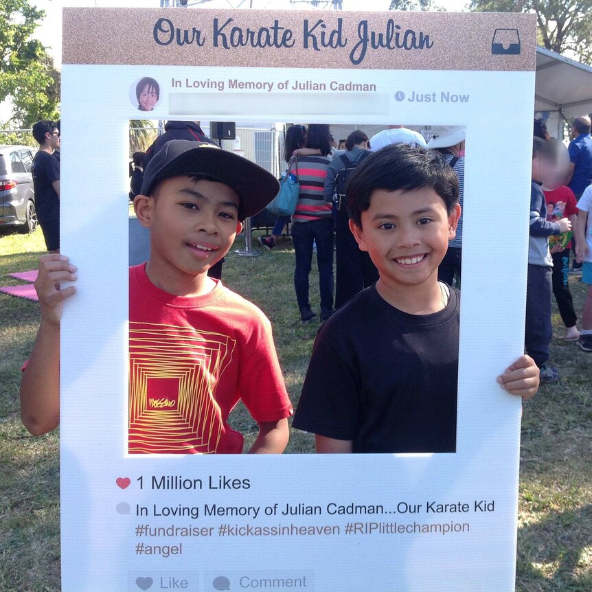 Two boys hold up a fake instagram frame saying "Our Karate Kid Julian"