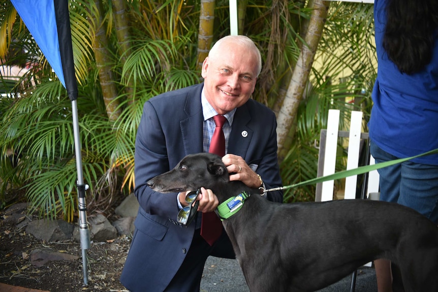 Queensland Racing Integrity Commissioner Ross Barnett with a greyhound.