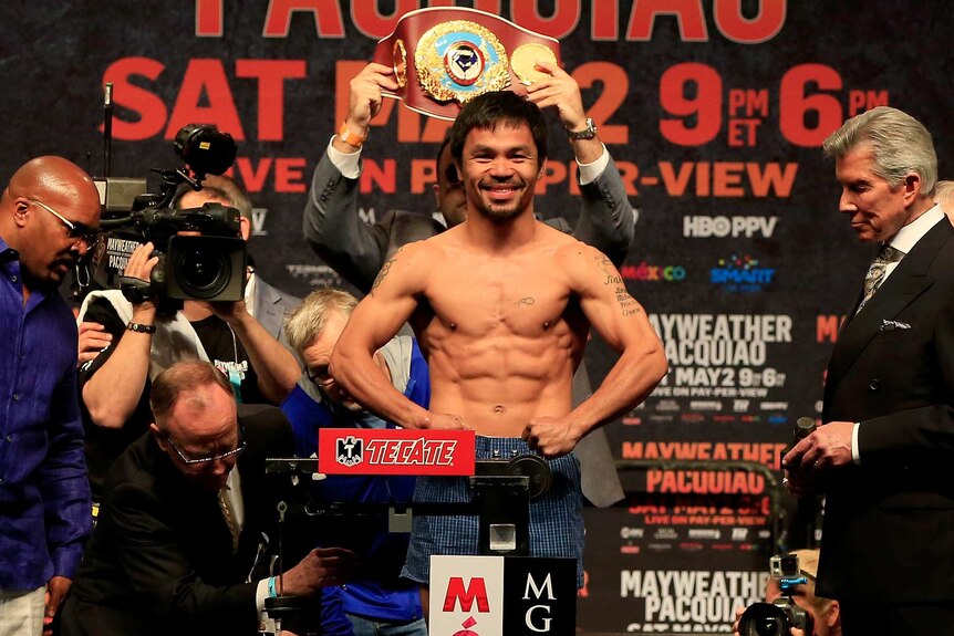 All smiles ... Manny Pacquiao poses on the scale during his official weigh-in at MGM Grand Garden Arena