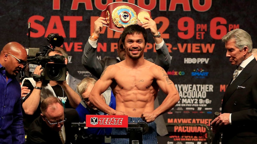 All smiles ... Manny Pacquiao poses on the scale during his official weigh-in at MGM Grand Garden Arena