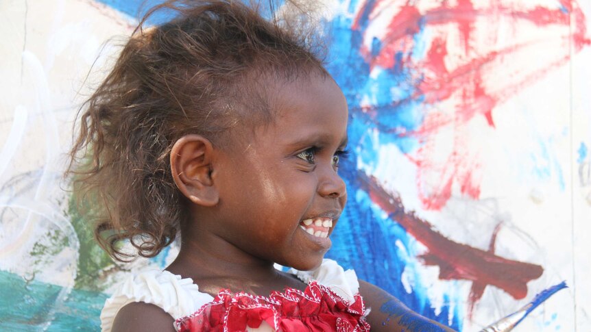 A child painting at the Children's Ground centre in Jabiru.