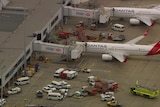 a plane on the tarmac surrounded by emergency fire vehicles.