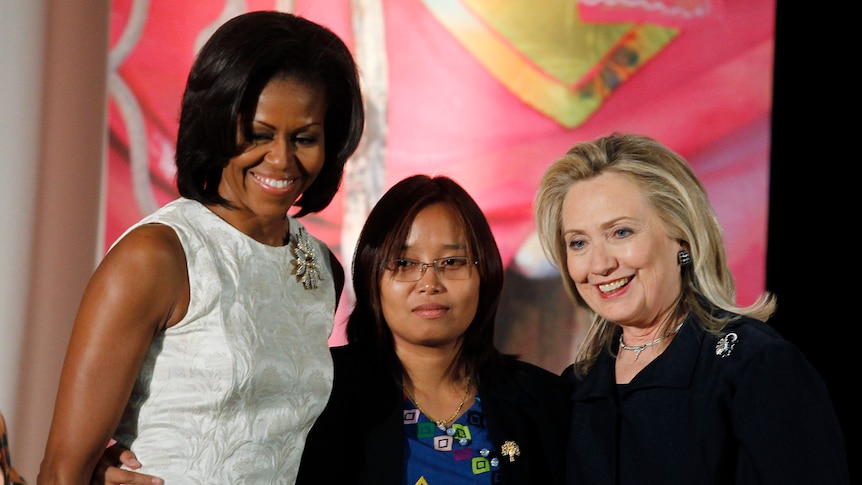 Zin Mar Aung standing between Michelle Obama and Hillary Clinton