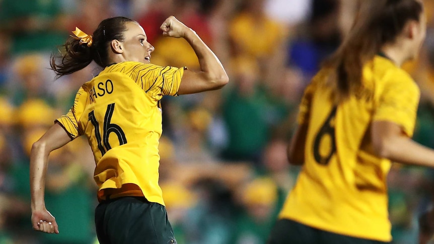 Hayley Raso leaps and punches the air after scoring a goal for Australia.