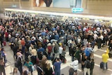Qantas passengers queue at LAX