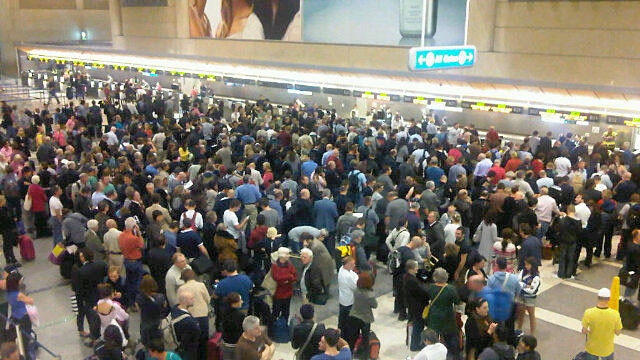 Qantas passengers queue at LAX