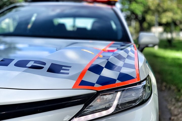 A police car on the side of a road.