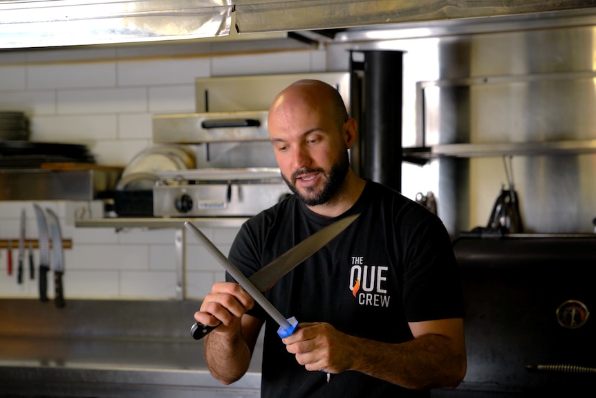 Chef Fabio uses a steel with his knife.
